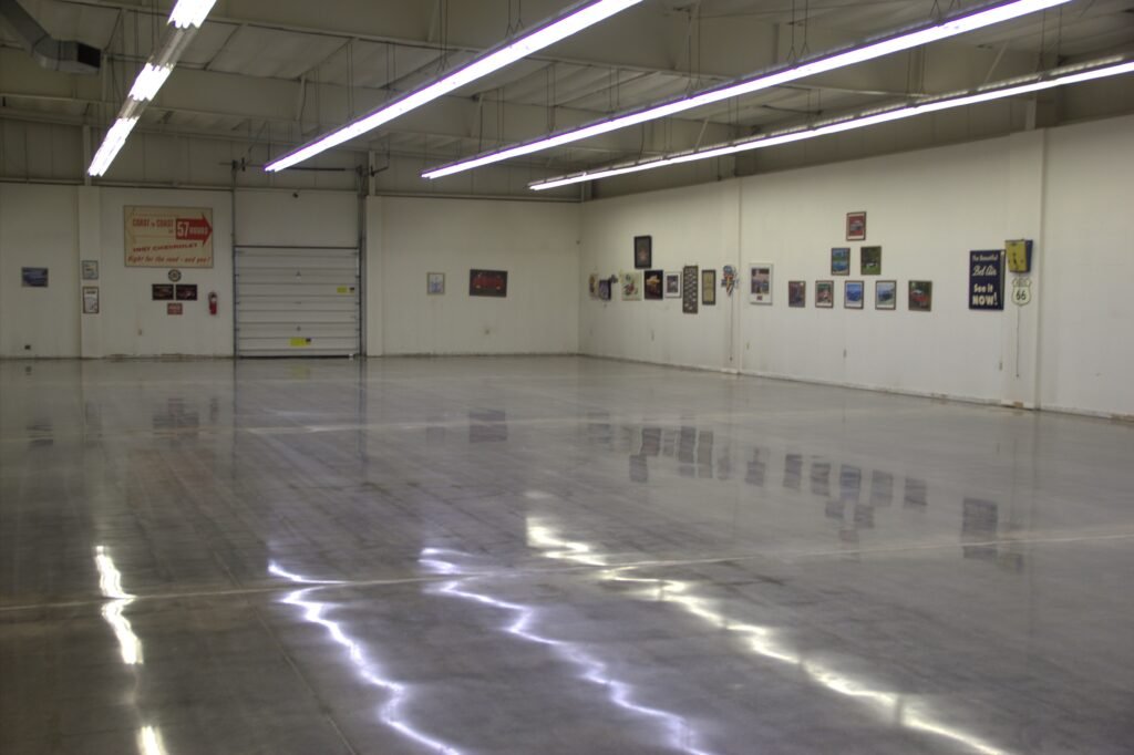 Mid level polished concrete floor showing the smooth and durable reflectivity of the walls and lighting. Made for a car showroom in Wisconsin.