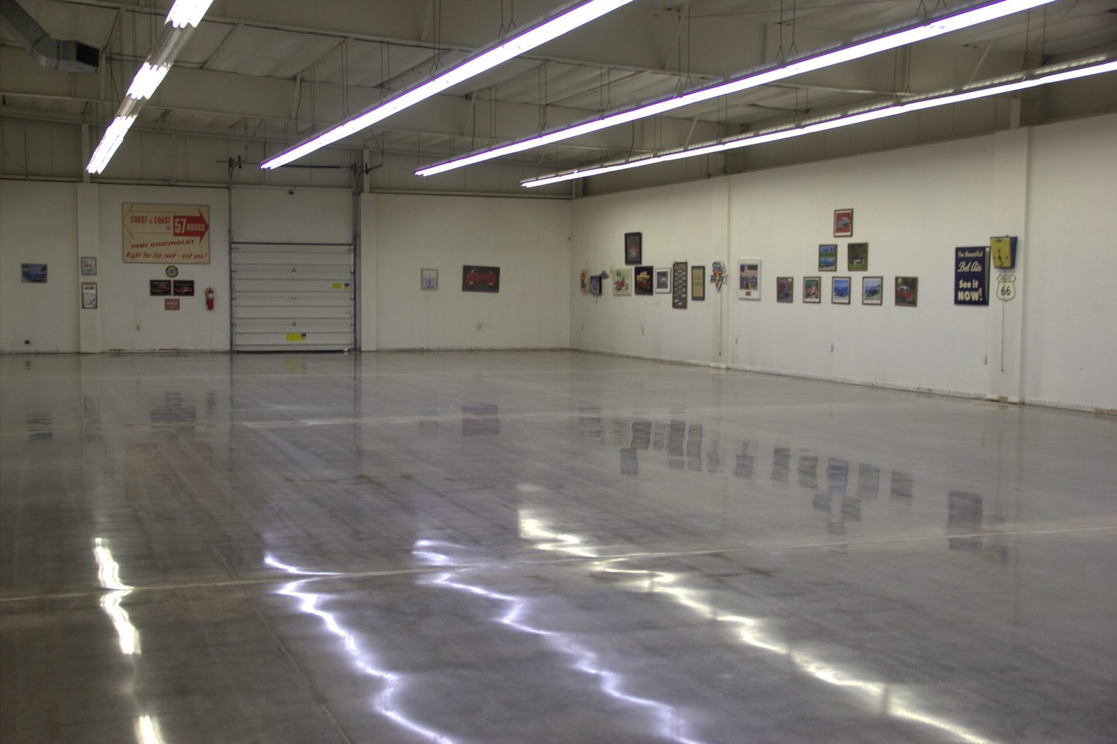 Mid level polished concrete floor showing the smooth and durable reflectivity of the walls and lighting. Made for a car showroom in Wisconsin.