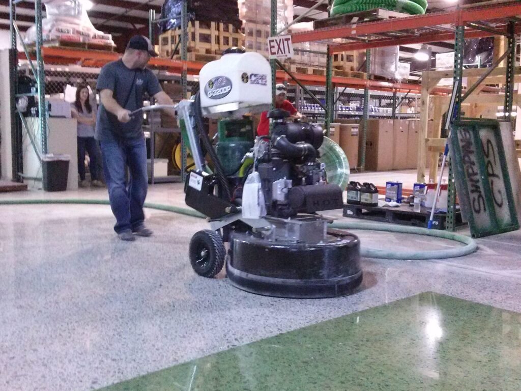 This is a photo of a CPS floor polishing machine polishing a concrete floor in a warehouse with some green dyed polished concrete.
