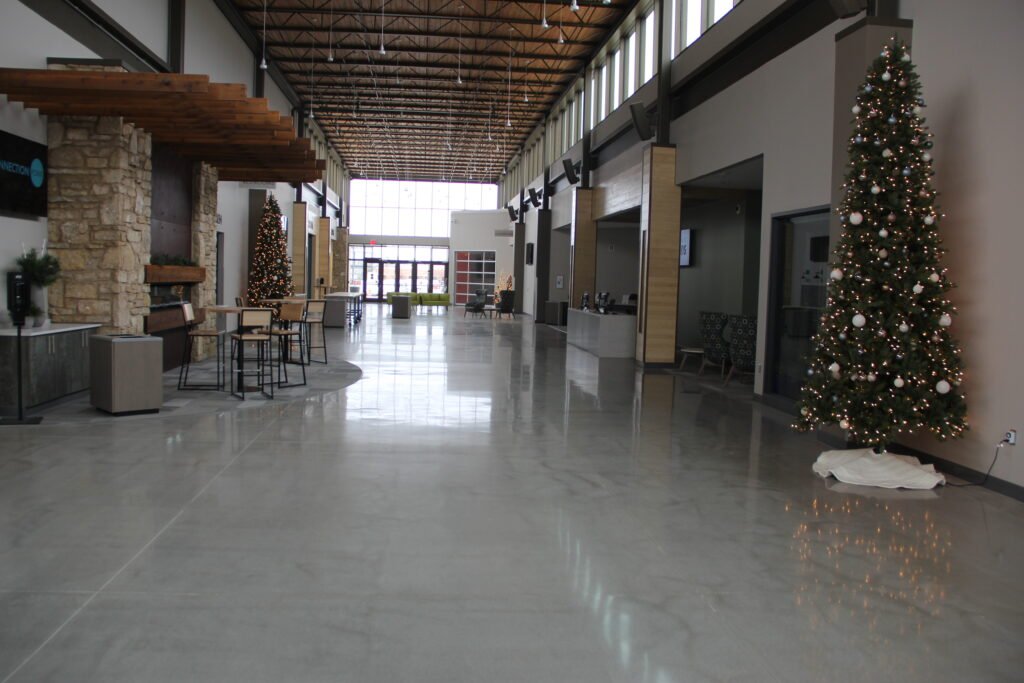 High-gloss polished concrete floor reflecting natural lighting from the windows. Church entryway based in Wisconsin.