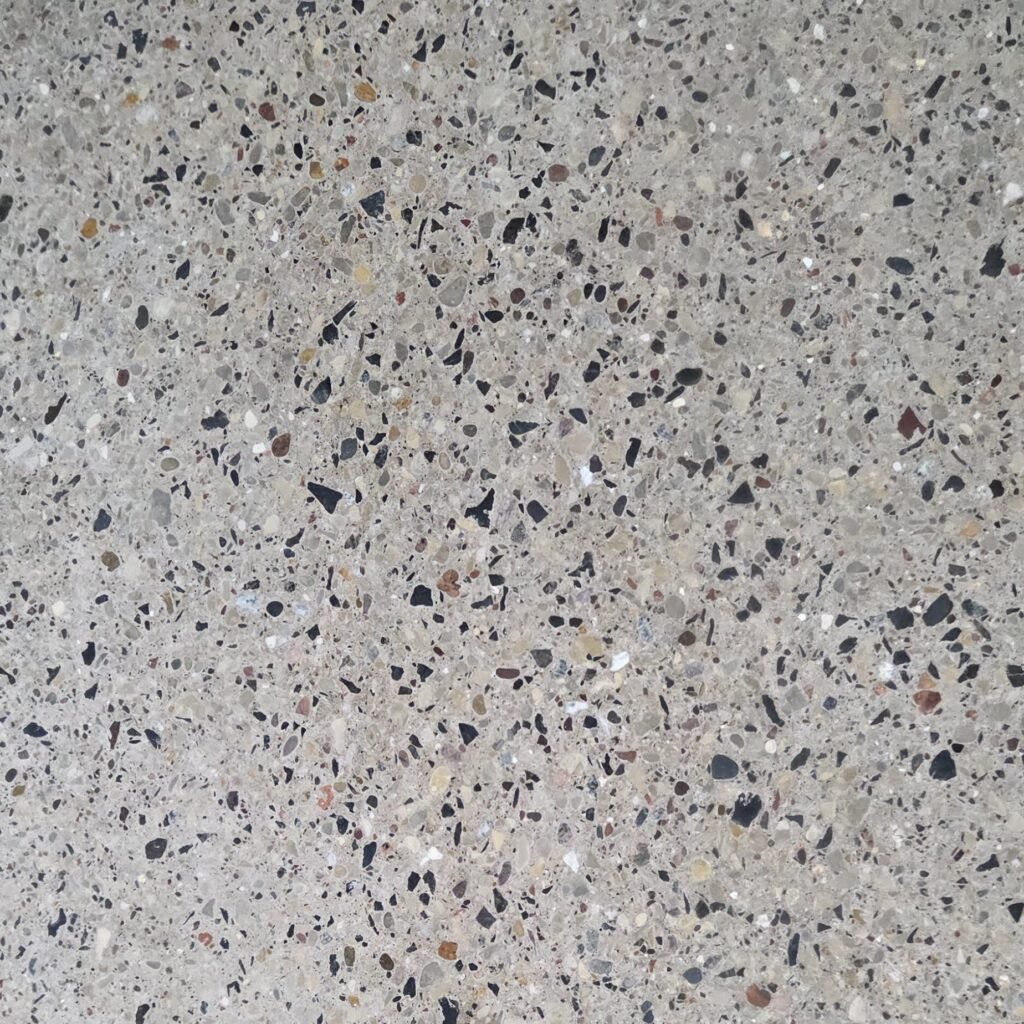 Close up photo of a polished concrete floor showing the different stones embedded in the concrete.