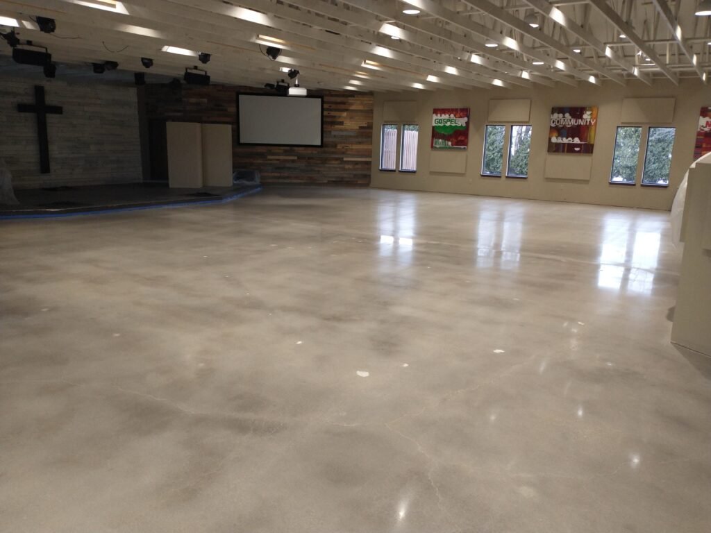 A polished concrete floor completed in a church in Madison wisconsin showing the glossy and smooth floor and the reflectivity from the windows.