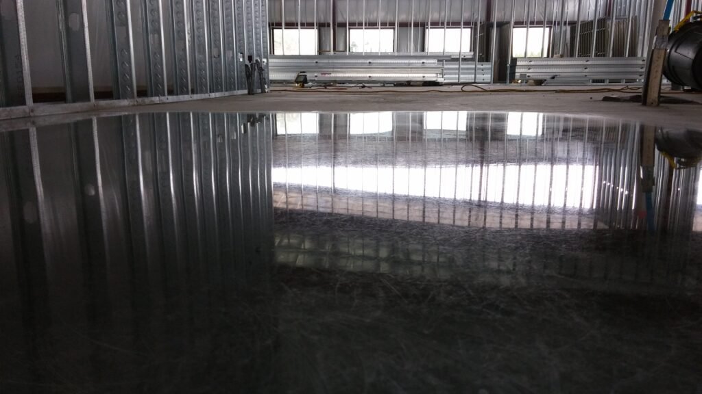 Polished concrete floor in a new construction building showing the reflectivity of the light.