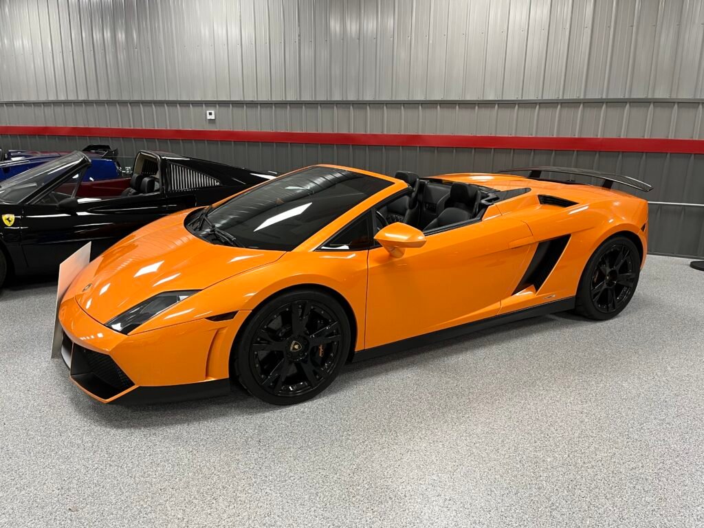 A yellow Lamborghini sitting on a polyaspartic chip concrete floor. Part of an automobile showroom.