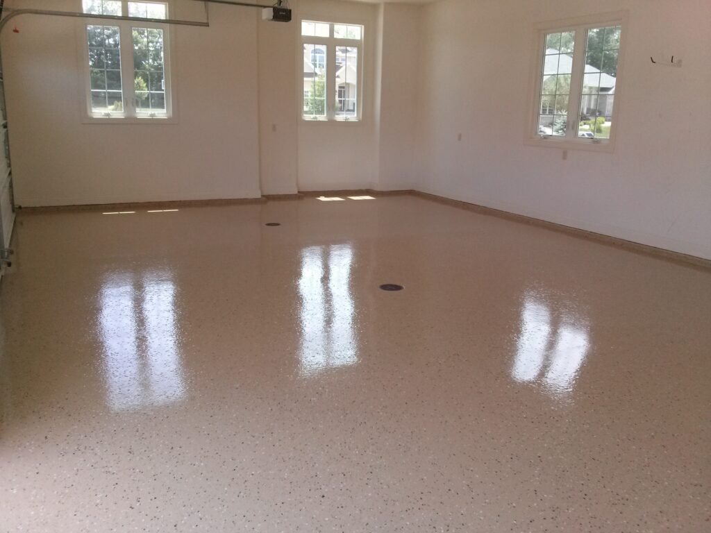 Tan polyaspartic conrete floor coating used in a residential garage in Wisconsin for its added durability and visual appeal.