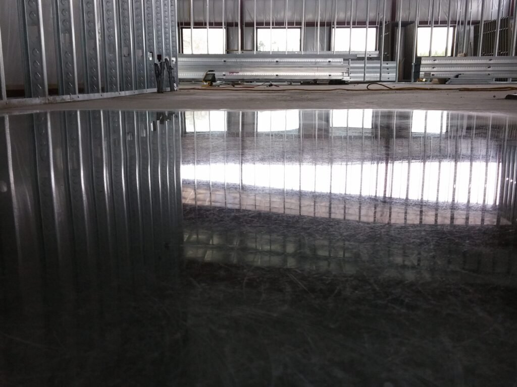 Polished concrete floor in a new construction building showing the reflectivity of the light.