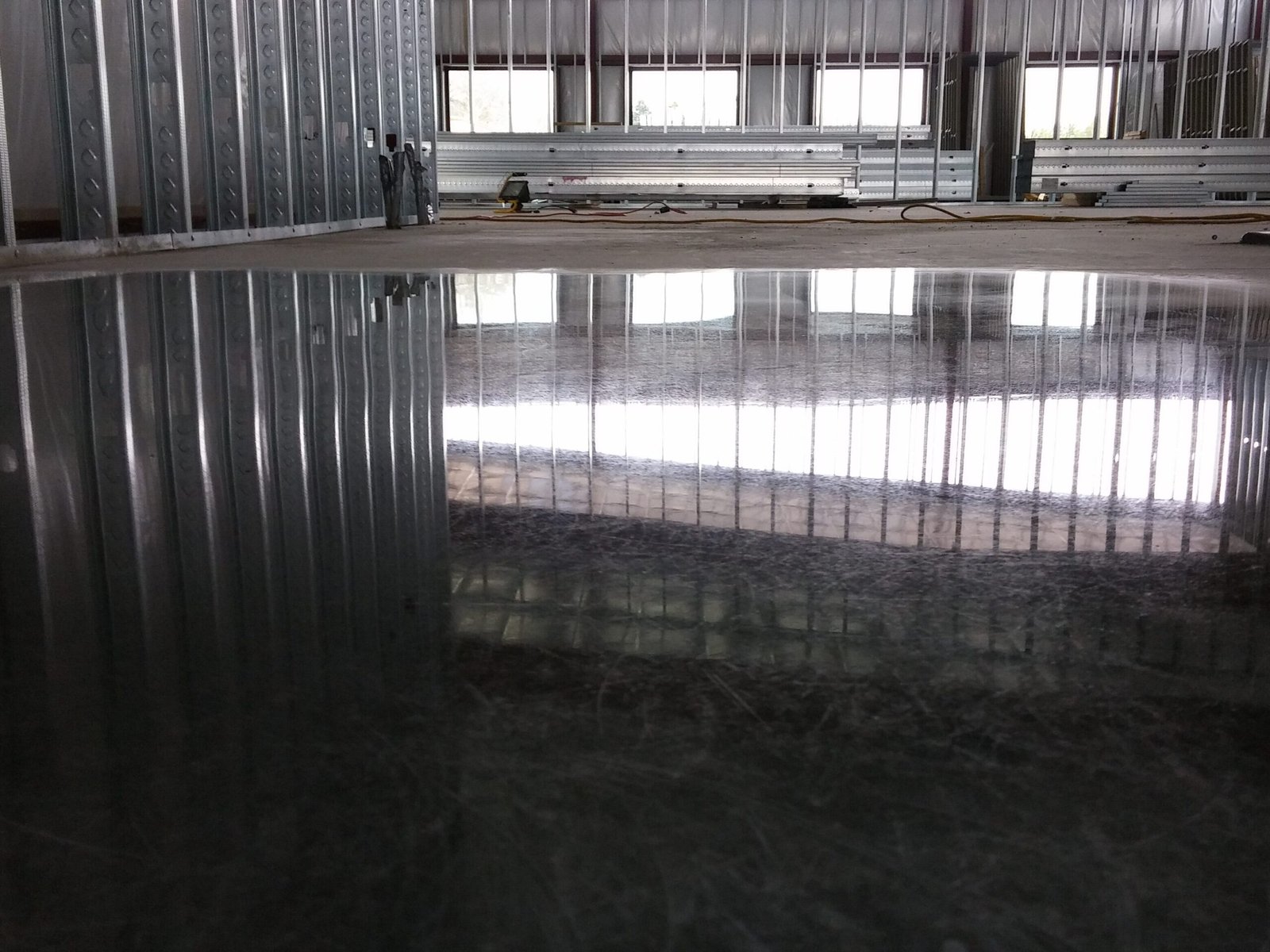 Polished concrete floor in a new construction building showing the reflectivity of the light.