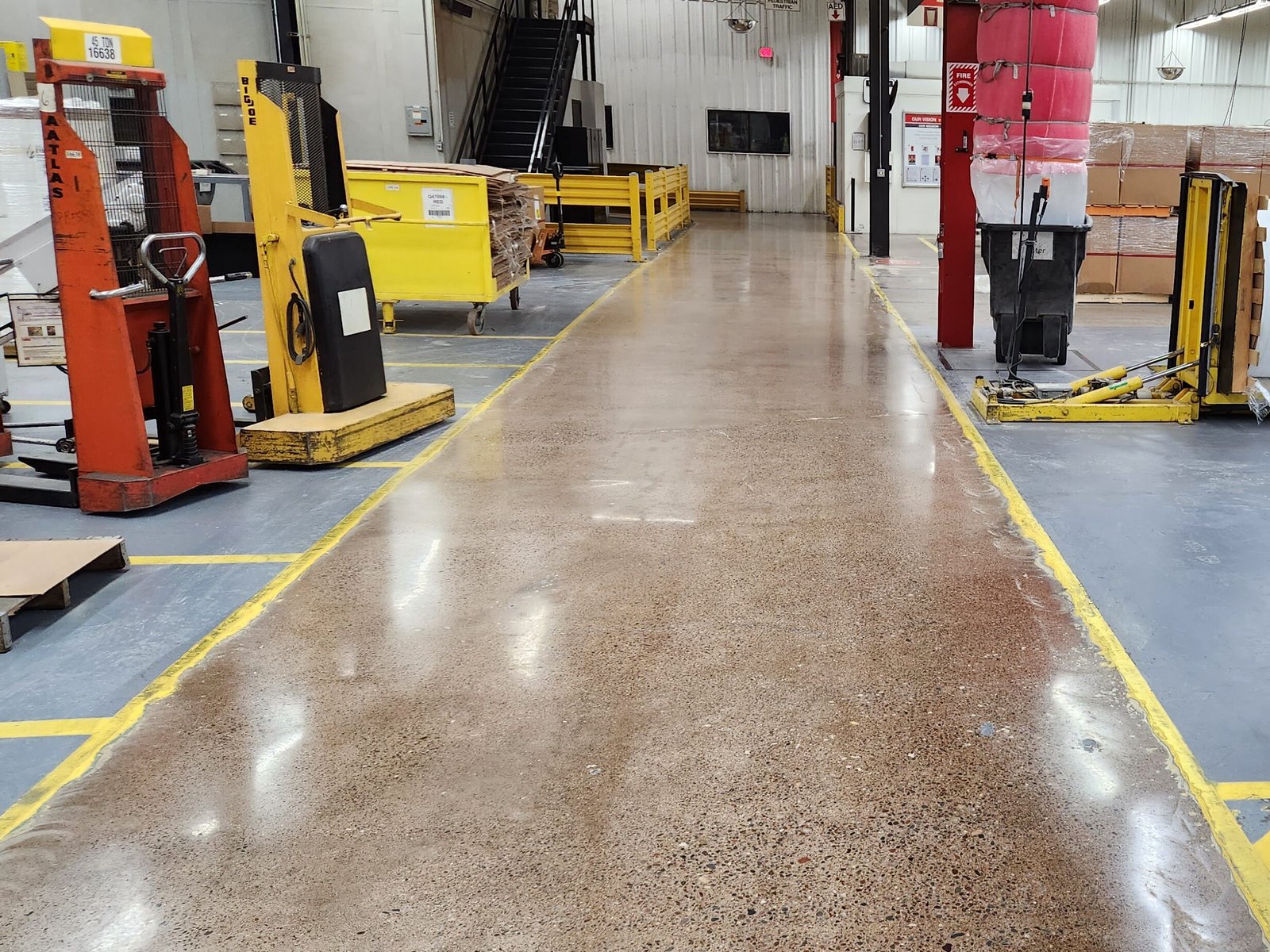 Polished concrete walkway in an industrial facility in Wisconsin. Shows the reflectivity and added durability of the floor.