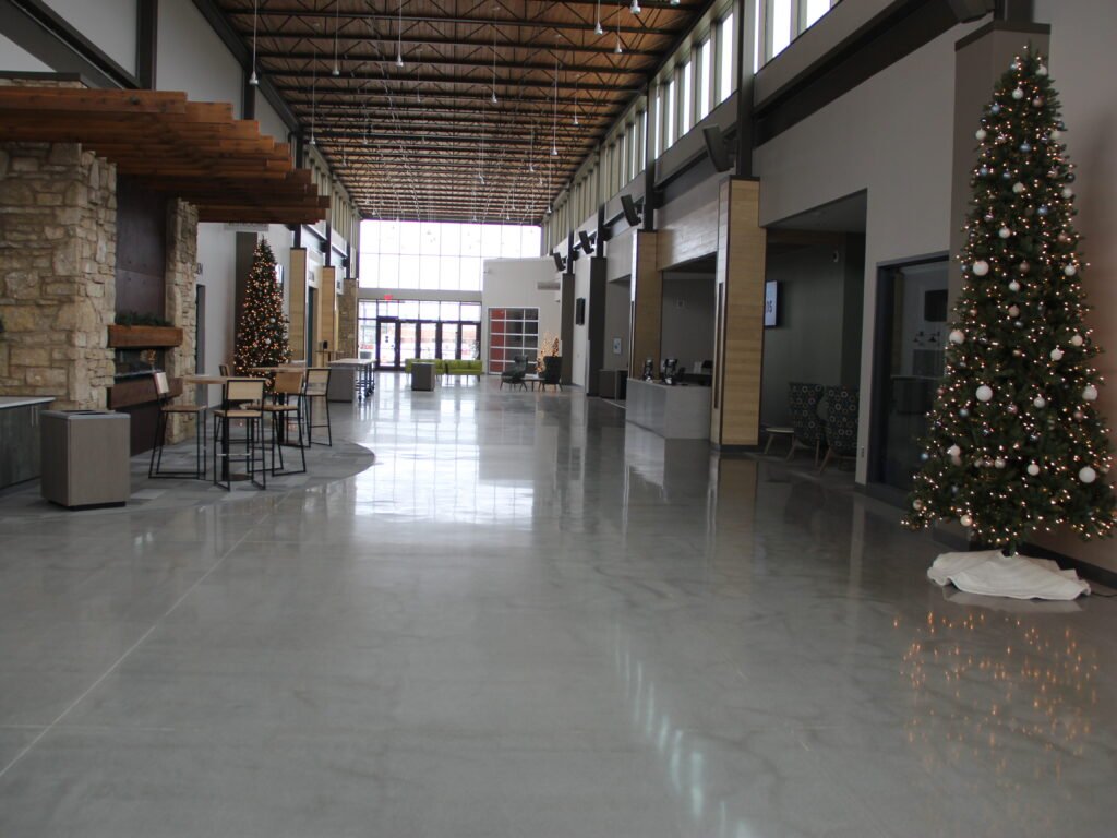 High-gloss polished concrete floor reflecting natural lighting from the windows. Church entryway based in Wisconsin.