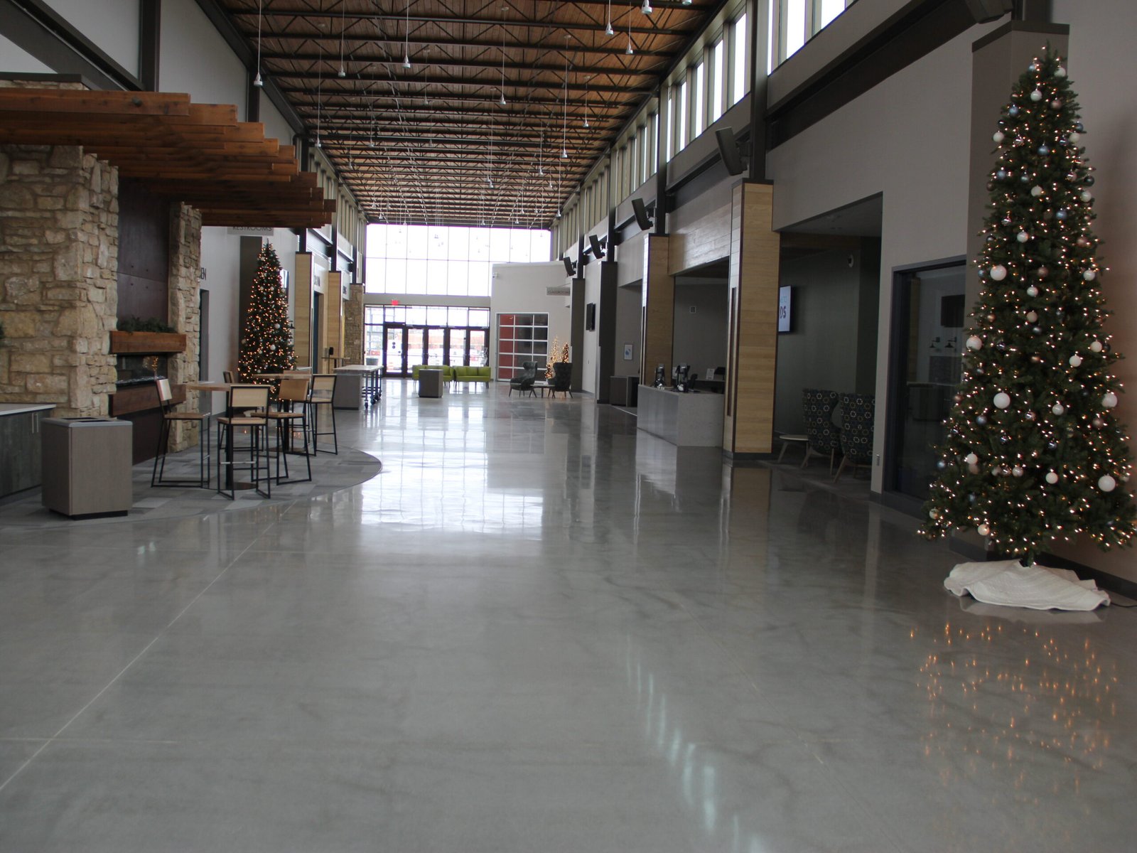 High-gloss polished concrete floor reflecting natural lighting from the windows. Church entryway based in Wisconsin.