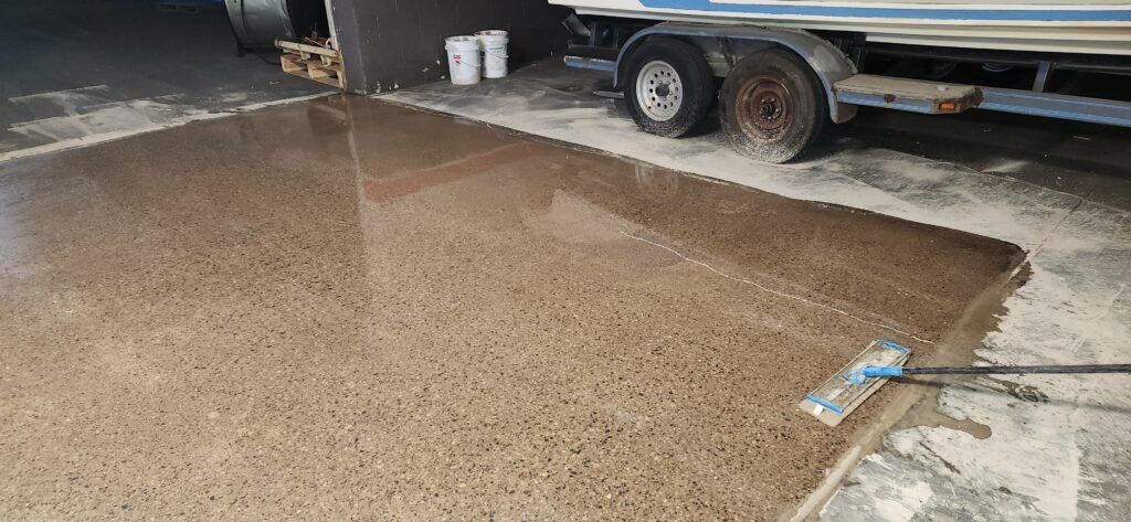 Application of a concrete densifier on a polished concrete floor as a concrete treatment.