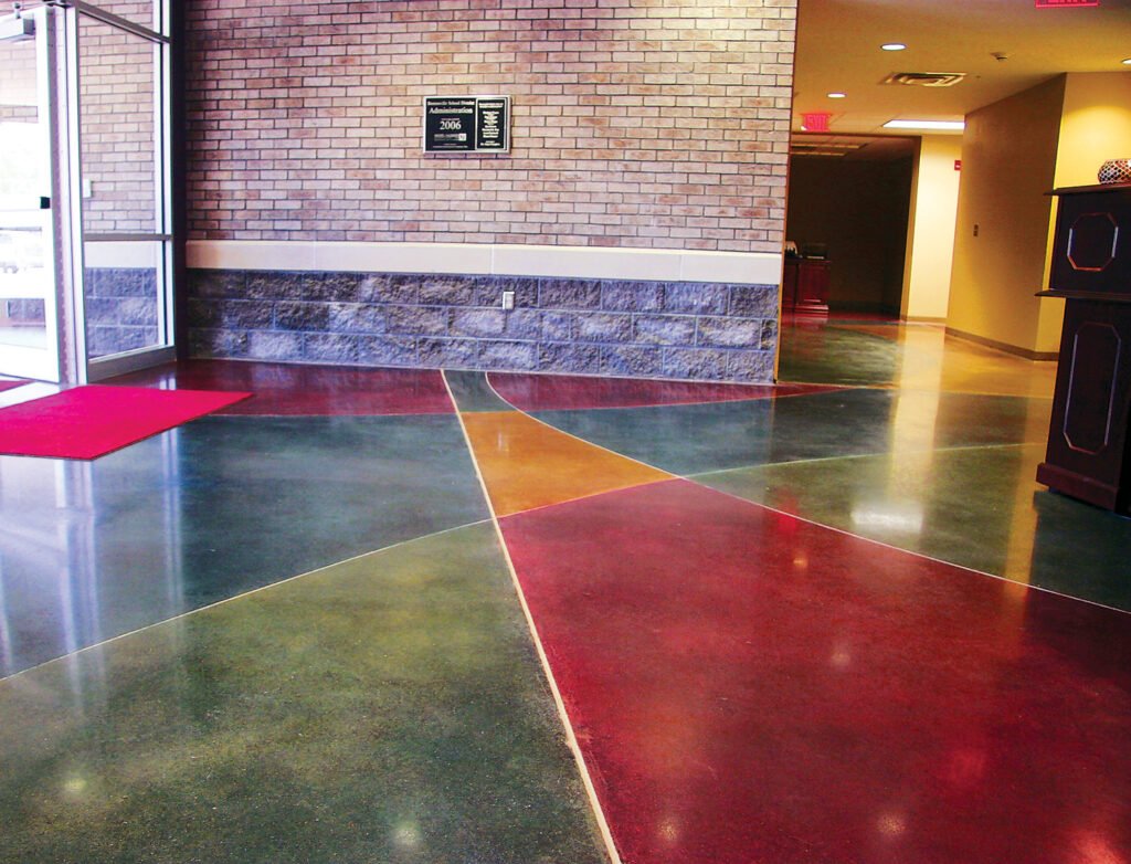 A beautiful terrazzo floor with red, green, and yellow inlays that has had terrazzo polishing and restoration performed.