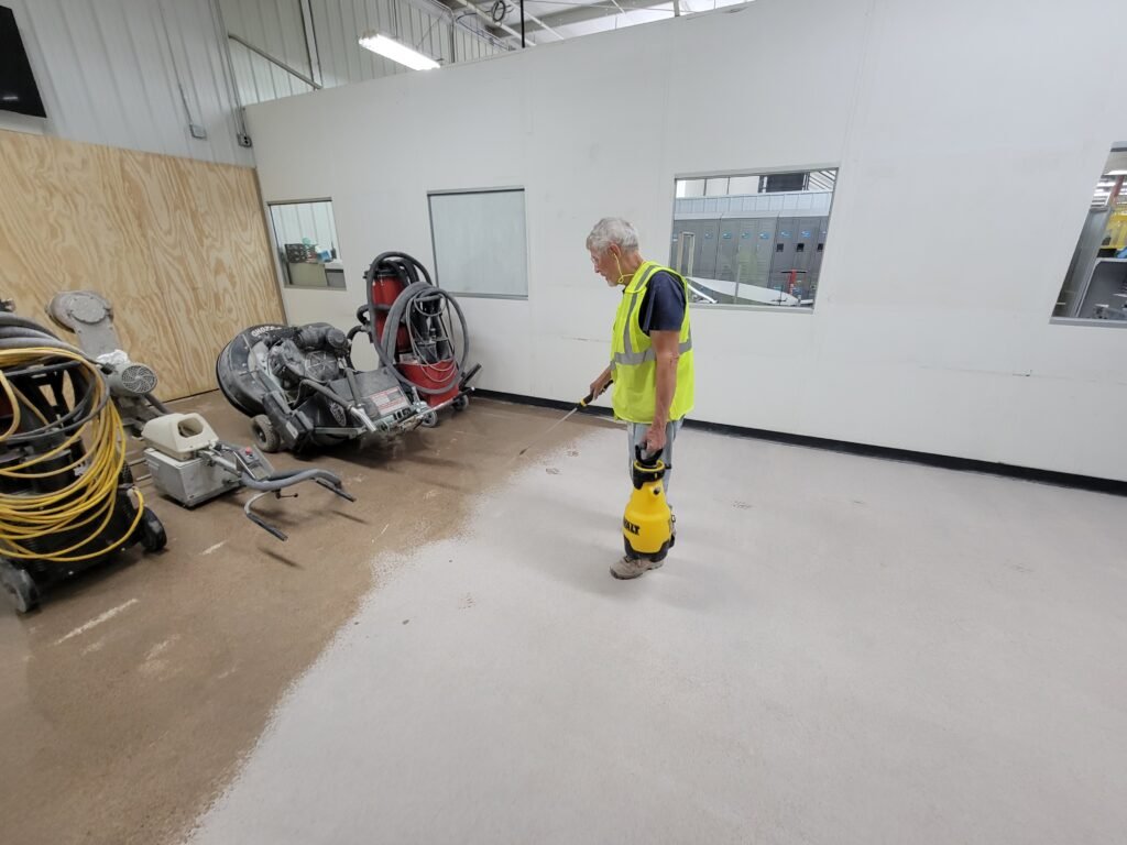 A concrete specialist applying a polished concrete guard for the polished concrete process in a manufacturing facility in Wisconsin.